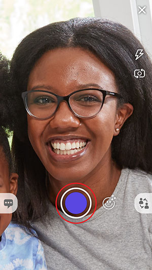 Show viewfinder with a mommy taking selfie with a red circle around the shutter icon
