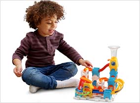 Child rolling a marble down the path of the Marble Rush Discovery Starter Set.