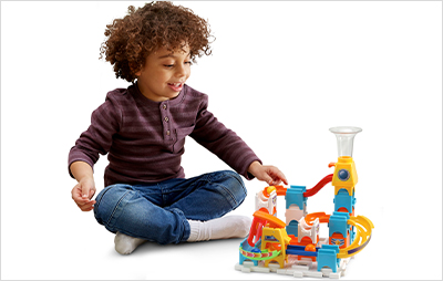 Child rolling a marble down the path of the Marble Rush Discovery Starter Set.