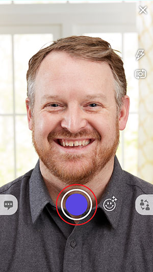 Show viewfinder with a daddy taking selfie with a red circle around the shutter icon
